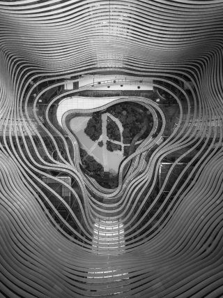 Aerial drone photography of a garden in the middle of curvy steel patterns - cool background An aerial drone photography of a garden in the middle of curvy steel patterns - cool background